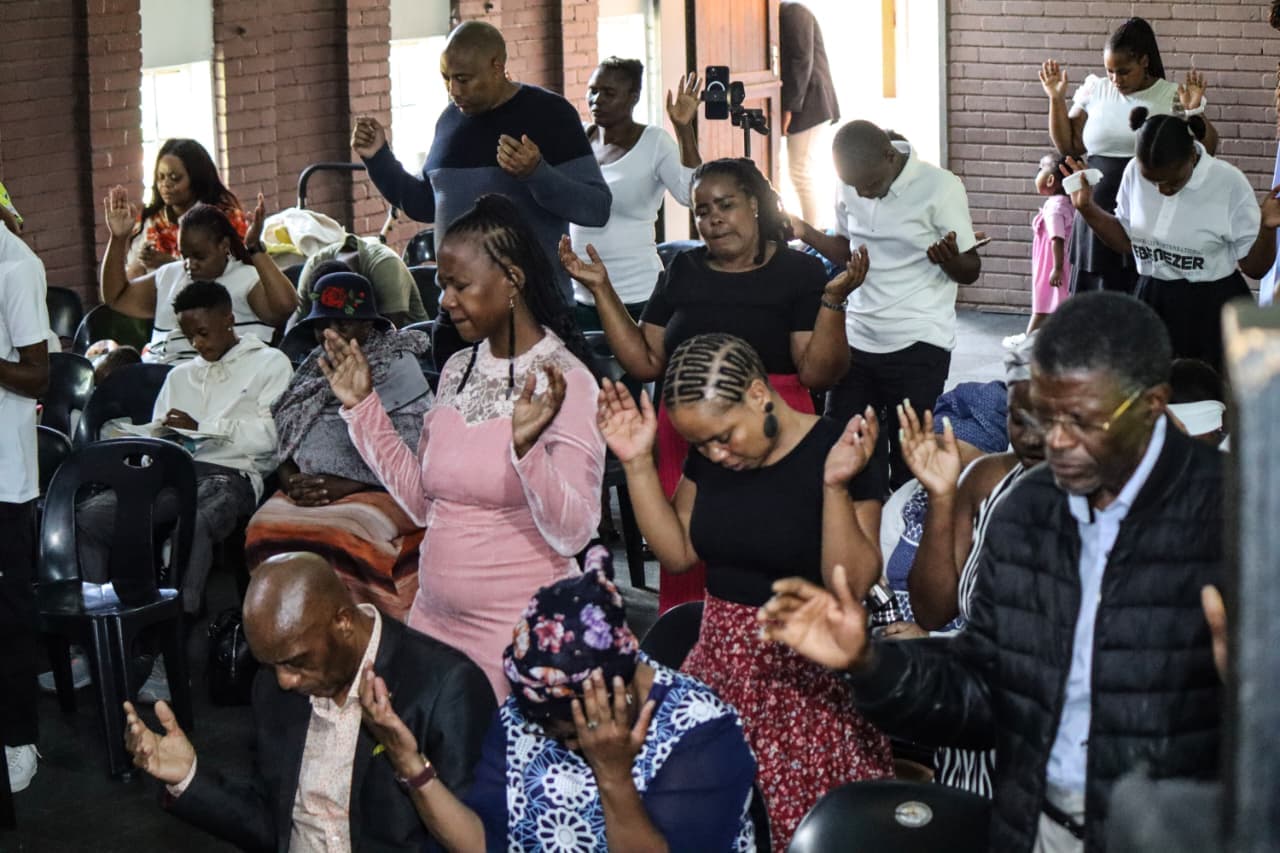 Lifted hands during worship at Renewed Life International.