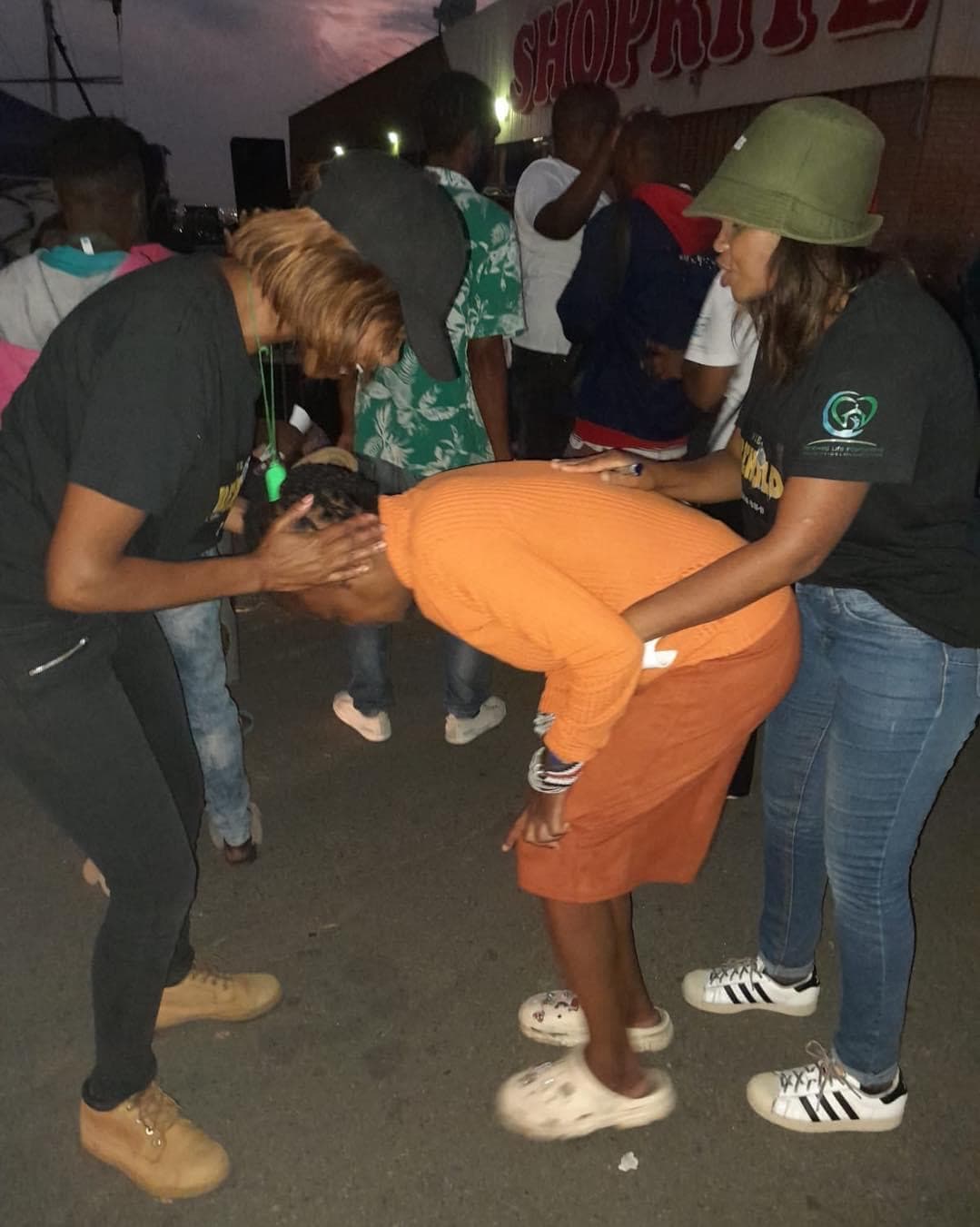 Prayer and healing ministry moment during outreach.