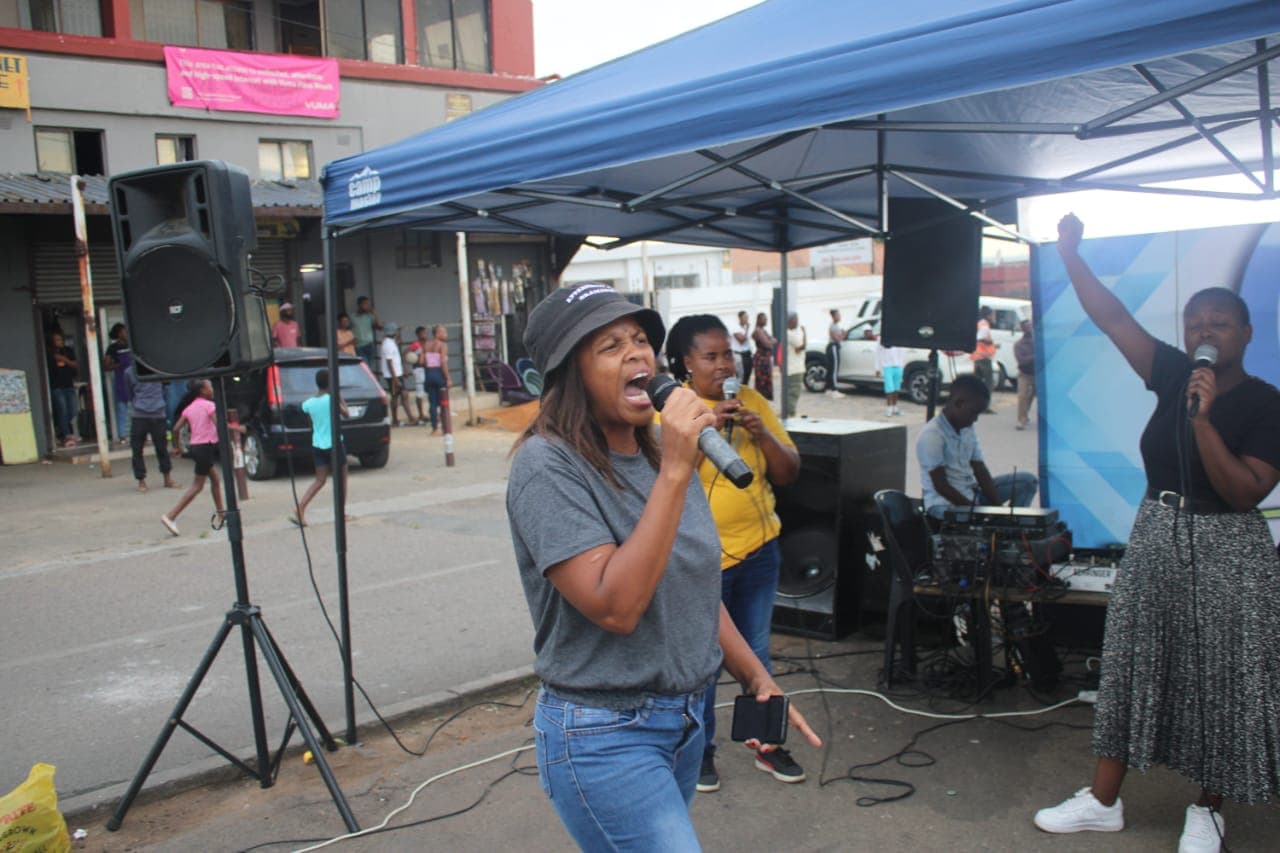 Open-air preaching moment from outreach ministry.